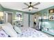 Serene bedroom with light-green walls, comfortable bedding, a ceiling fan, and charming décor at 17072 Newberry Ln, Westfield, IN 46074