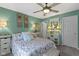 A comfortable bedroom featuring floral bedding, decorative accents, and soothing light-green walls at 17072 Newberry Ln, Westfield, IN 46074