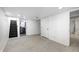 Finished basement with light wood-look flooring, neutral walls, and access to laundry area at 2009 N Bosart Ave, Indianapolis, IN 46218