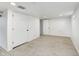 Spacious basement with wood-look flooring, white trim, and ample storage space with multiple closets at 2009 N Bosart Ave, Indianapolis, IN 46218