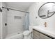 Updated bathroom with stylish tile, shower, modern vanity, and round mirror at 2009 N Bosart Ave, Indianapolis, IN 46218