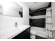 Stylish bathroom featuring contrasting black and white tiles, modern fixtures, and a shower-tub combination at 2009 N Bosart Ave, Indianapolis, IN 46218
