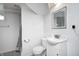 Basement bathroom with a white vanity, toilet, and tiled shower with curtain at 2009 N Bosart Ave, Indianapolis, IN 46218