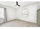 Bedroom with neutral paint, ceiling fan, and a large window at 2009 N Bosart Ave, Indianapolis, IN 46218