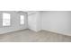 Bright bedroom with a closet, light-colored flooring, and large windows at 2009 N Bosart Ave, Indianapolis, IN 46218
