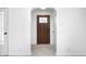 Welcoming entryway featuring a solid wood door, new flooring, and white trim at 2009 N Bosart Ave, Indianapolis, IN 46218