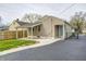 Tan house with a covered patio, fenced yard, and a well-maintained exterior at 2009 N Bosart Ave, Indianapolis, IN 46218