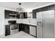 Modern kitchen featuring stainless steel appliances, dark wood cabinets, and new backsplash at 2009 N Bosart Ave, Indianapolis, IN 46218