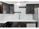 Stylish kitchen with stainless steel appliances, floating shelves, and light countertops at 2009 N Bosart Ave, Indianapolis, IN 46218