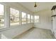 Cozy sunroom featuring several large windows and light-colored flooring at 2009 N Bosart Ave, Indianapolis, IN 46218