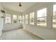 Bright sunroom with many windows, providing ample natural light and lovely neighborhood views at 2009 N Bosart Ave, Indianapolis, IN 46218