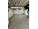 Unfinished basement with concrete floor and white painted ceiling and walls at 2115 N Leland Ave, Indianapolis, IN 46218