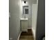 Bathroom featuring a single sink vanity, mirror, and walk-in shower at 2115 N Leland Ave, Indianapolis, IN 46218