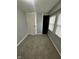 Bedroom with neutral carpet, gray walls, two windows with blinds and a door with white trim at 2115 N Leland Ave, Indianapolis, IN 46218