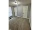 Bedroom with gray walls, neutral carpet, white trim and doors and a window with blinds at 2115 N Leland Ave, Indianapolis, IN 46218