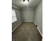 Bedroom with neutral carpet, gray walls, white trim, and a window with blinds at 2115 N Leland Ave, Indianapolis, IN 46218