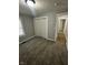 Bedroom with neutral colored carpet, closet, and view of hallway with wood floors and white trim at 2115 N Leland Ave, Indianapolis, IN 46218