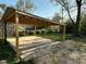 Carport with concrete pad and wood supports at 2115 N Leland Ave, Indianapolis, IN 46218