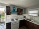 Bright kitchen with stainless steel appliances, white subway tile backsplash, and wood-look flooring at 2115 N Leland Ave, Indianapolis, IN 46218