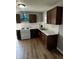 Well-lit kitchen with stainless steel appliances, white subway tile backsplash, and wood-look flooring at 2115 N Leland Ave, Indianapolis, IN 46218