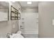 Bathroom with tiled walls, shower/tub combo, and a modern sink at 221 N Munsie St, Indianapolis, IN 46229
