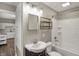 Bathroom with tiled walls, shower/tub combo, and a modern sink at 221 N Munsie St, Indianapolis, IN 46229