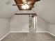 Carpeted bedroom featuring a wood beam ceiling, ceiling fan, and ample lighting at 221 N Munsie St, Indianapolis, IN 46229