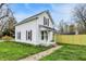 Charming two-story home with fresh siding and a well-maintained front yard and sidewalk at 221 N Munsie St, Indianapolis, IN 46229