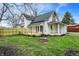 Charming two-story home featuring a spacious yard, wooden deck, and classic architectural details at 221 N Munsie St, Indianapolis, IN 46229