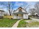A white two-story home showcases a fresh wooden fence and a well-maintained lawn at 221 N Munsie St, Indianapolis, IN 46229