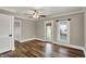 Bright living room showcasing hardwood floors, ceiling fan, and white trim throughout at 221 N Munsie St, Indianapolis, IN 46229