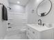 This bathroom has a shower-tub combo, modern vanity, and a round mirror at 2326 Guilford Ave, Indianapolis, IN 46205