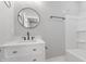 Bright bathroom with undermount sink, black faucet, and tub at 2326 Guilford Ave, Indianapolis, IN 46205