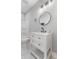 This bathroom has a shower-tub combo, modern vanity with a black faucet and a round mirror at 2326 Guilford Ave, Indianapolis, IN 46205