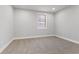 Well-lit bedroom with neutral carpet, gray walls, and window at 2326 Guilford Ave, Indianapolis, IN 46205