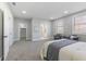This bedroom features a bed, chairs, two windows, and carpet at 2326 Guilford Ave, Indianapolis, IN 46205