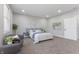 This bedroom features a bed, chairs, a window, and carpet at 2326 Guilford Ave, Indianapolis, IN 46205
