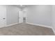 This bedroom features neutral walls, carpet, a door, and an entry to another room at 2326 Guilford Ave, Indianapolis, IN 46205