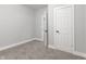 This bedroom features neutral walls, carpet, a door, and an entry to another room at 2326 Guilford Ave, Indianapolis, IN 46205