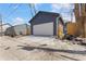 A detached two-car garage with a concrete driveway and blue painted siding, adjacent to a wood privacy fence at 2326 Guilford Ave, Indianapolis, IN 46205