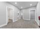 Hallway with access to a bathroom and rooms with neutral-colored walls at 2326 Guilford Ave, Indianapolis, IN 46205
