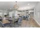 Modern kitchen with white cabinets, black and white marble countertops, and a unique lighting fixture above the dining table at 2326 Guilford Ave, Indianapolis, IN 46205
