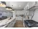 Modern kitchen with a large island, white cabinets, black accents, and stainless steel appliances at 2326 Guilford Ave, Indianapolis, IN 46205