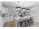 Beautiful kitchen with a large island and marble countertops, stainless steel appliances, and bright pendant lighting at 2326 Guilford Ave, Indianapolis, IN 46205