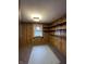 Cozy bedroom with wood paneling, built-in shelving, and a window with decorative curtains at 2365 E 850 N, Lebanon, IN 46052