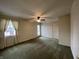 Bedroom featuring green carpet, wallpapered walls, with a window and door to the exterior at 2365 E 850 N, Lebanon, IN 46052
