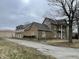 Exterior view showcasing the house with a brick facade and attached three-car garage at 2365 E 850 N, Lebanon, IN 46052