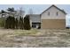 Back exterior view of house with screened in porch and mature landscaping at 2365 E 850 N, Lebanon, IN 46052