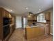 Eat-in kitchen featuring oak cabinets, tile floors, stainless steel appliances, laminate countertops and a pass through at 2365 E 850 N, Lebanon, IN 46052