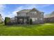 Manicured backyard with covered patio, garden and trampoline at 2798 W High Grove Cir, Zionsville, IN 46077